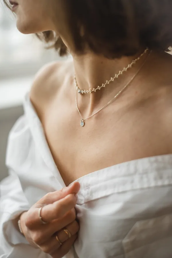 Model wearing a layered necklace